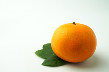 Ripe tangerines and Green orange leaves isolated on white background. Concept for Chinese Lunar New Year.