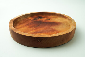 Close-up photo of Circular Wooden plate isolated on white background. Shot on 30 Degree angle setup.
