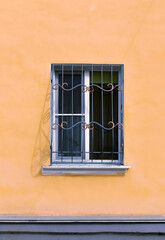 window on the facade of an old building, the walls of the building with peeling plaster