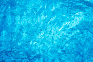 Grungy blue textured paper background with faded watercolor paint stains.