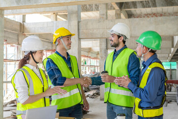 Engineer handshake,contractor on construction site to implement planning a new building,teamwork,contract property,real estate home project