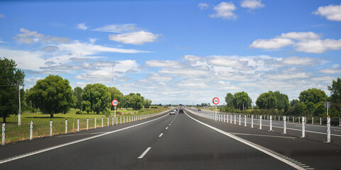 Fototapeta premium Driving on Waikato Expressway. 110 kmh road speed signs by the side of motorway. New Zealand.