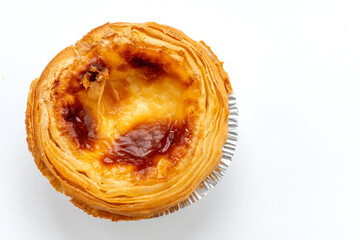 A close up of a baked egg tart isolated on white.