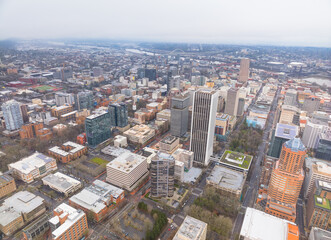 Fototapeta premium A city view from above with tall buildings and a green roof
