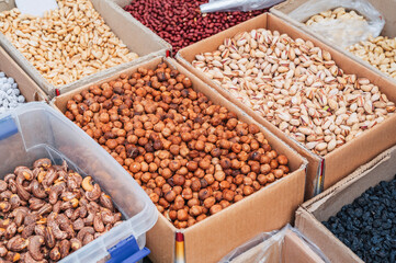 Rich assortment of nuts and dried fruits on counter at wholesale market. Healthy nutrition, Vegan sweets.