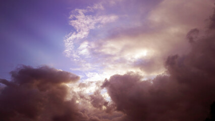 Obraz premium Purple Sunset Breaking Through Clouds