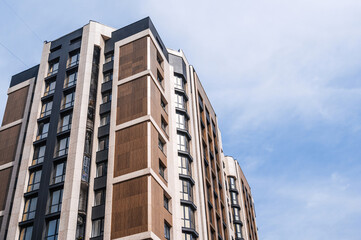 The facade of a new apartment building against the sky .