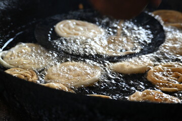 Jalebi making. It is a popular sweet snack in India subcontinent. It is many names jilapi, jilebi, jilipi, zulbia, mushabak, z’labia and zalabia. Its made by maida flour batter and sugar syrup.