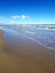 Sandy beach and blue sky with clouds, Baltic Sea, Poland