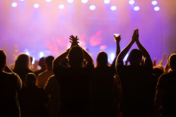 Crowd at concert and blurred stage lights.