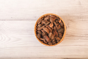 Black cardamoms or Greater Cardamoms on wooden table	

