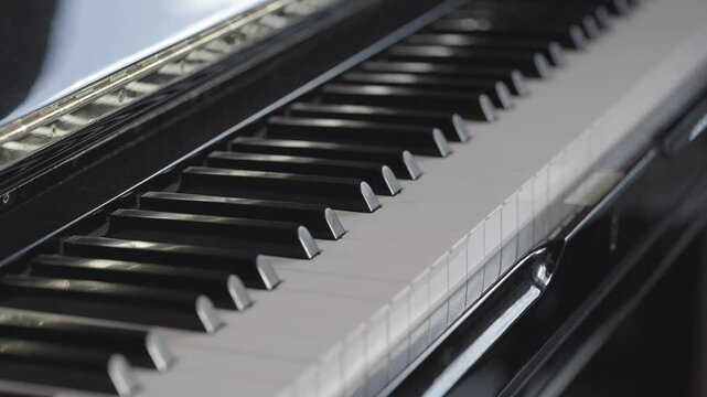 Black and white piano keys details, musical instrument, Selective focus, tracking shot