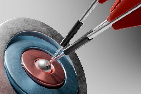 Close-up of darts hitting the bullseye on a target