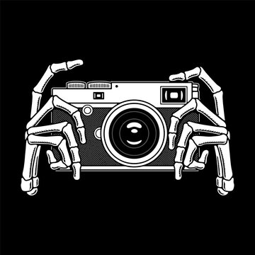 SKELETON HANDS HOLDING PHOTO CAMERA WHITE BLACK BACKGROUND