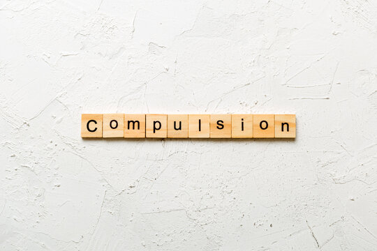compulsion word written on wood block. compulsion text on table, concept