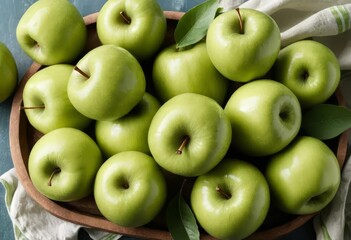 A close-up of a green apple with a smoothie in the background