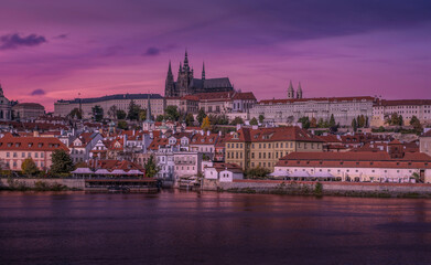 Sunset over Prague showcasing historic architecture and serene river reflections