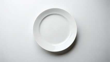 A pristine white plate, top view, against a pure white backdrop. Ideal stock photo.
