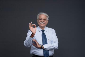 Elderly Man Showing an Super Sign