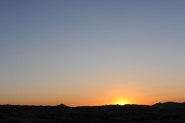 Beautiful sunset with clear sky in the mountains on the desert
