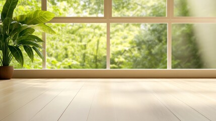 Bright indoor space with a plant and large window overlooking greenery.