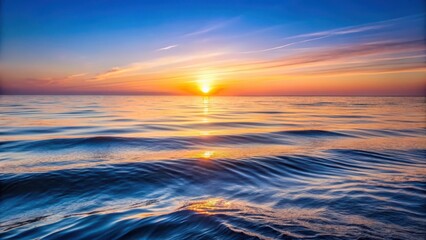Fototapeta premium Softly glowing waves create ripples on the surface of a tranquil ocean as the first light of dawn creeps over the horizon, calm morning by sea, early morning sea