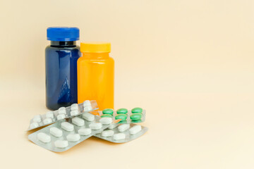 bottles with capsules, blister packs of tablet on light pastel background