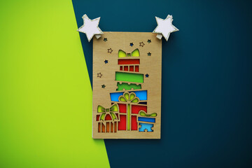 Colorful Gift Boxes with Stars on Green and Blue Background - Festive Holiday Card Design