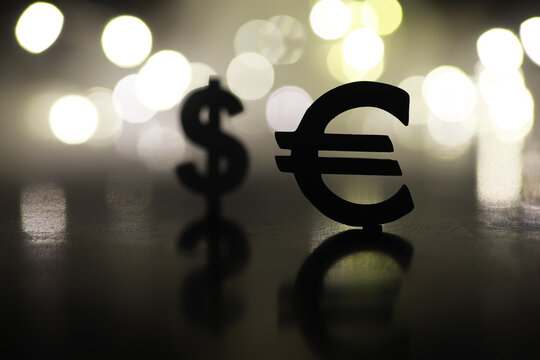 Dollar and Euro Symbols with Bokeh Background in Soft Focus Light Reflections