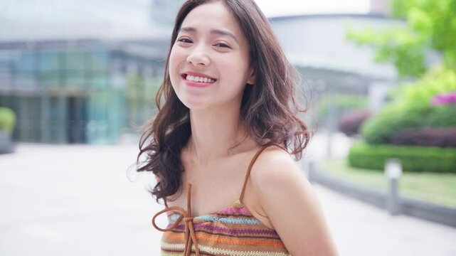young asian woman looking at camera smile