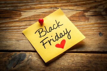 Black Friday Sale Handwritten Note on Yellow Sticky Note with Red Heart - Top View