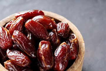 Organic Dried Dates in Rustic Wooden Bowl, Ramadan and Middle Eastern Cuisine