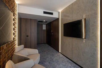 Wall mounted tv on marble wall in hotel lobby