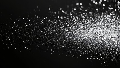 Obraz premium Sparkling silver particles creating a mesmerizing effect on a dark background for artistic and creative projects