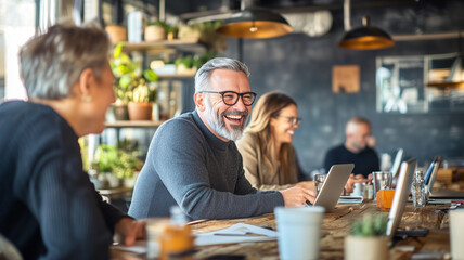 Happy people working together in modern office space, collaborating and sharing ideas. atmosphere is lively and productive, with plants and laptops enhancing environment
