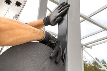 Applying Self-adhesive Noise-absorbing Tape to a Metal Construction