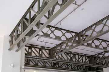 Intricate metal framework supporting a ceiling in modern architecture