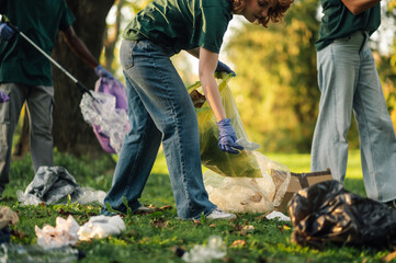 Group of volunteers picking up trash in park