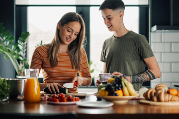 Lesbian couple preparing healthy meal together in modern kitchen