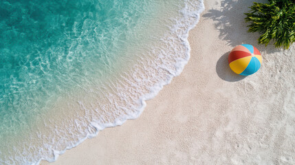 Obraz premium Aerial view of beach with turquoise water and colorful beach ball