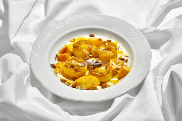 A traditional Ukrainian breakfast dish, syrniki, served with fresh fruit, nuts, and a drizzle of honey.