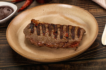 Grilled beef striploin steak with sauce