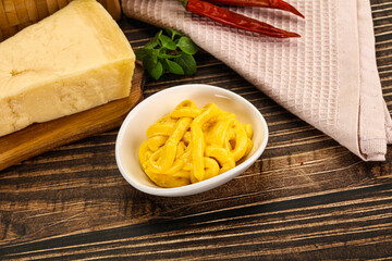 Yellow cheese sauce in the bowl