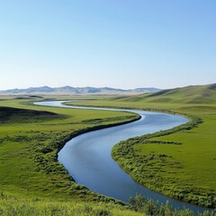Serpentine river meandering through lush green plains under a clear blue sky.