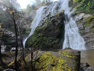 Khlonglan waterfall with moss in rainforest.