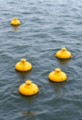 Wave energy converters, buoys on water, studio photography, with white tones