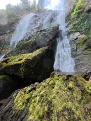 Khlonglan waterfall with moss in rainforest.