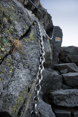 Belaying, chains in difficult places on a high mountain trail in the High Tatras.
