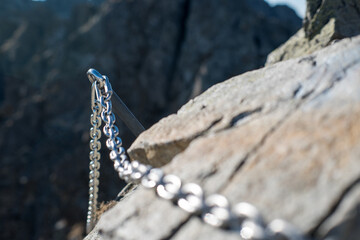 Belaying, chains in difficult places on a high mountain trail in the High Tatras.

