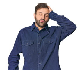 Studio portrait of young Hispanic male tired and very sleepy keeping hand on head.